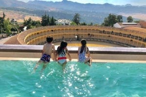 Spain Vacation Families, Three children in pool overlooking Spain