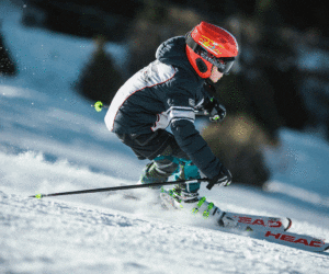Boy skiing with red helmet