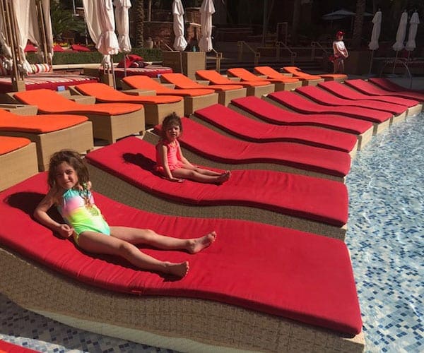 Two girls lean back on pool-side loungers at the Red Rock Resort & Spa in Las Vegas.