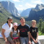 Family posing on stone wall at Yosemite National Park