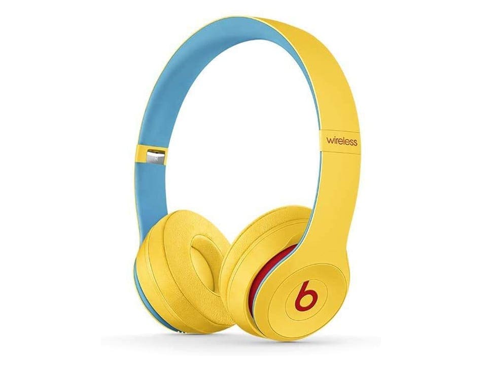 Product shot of a pair of Beats Solo3, with a yellow exterior and blue interior.