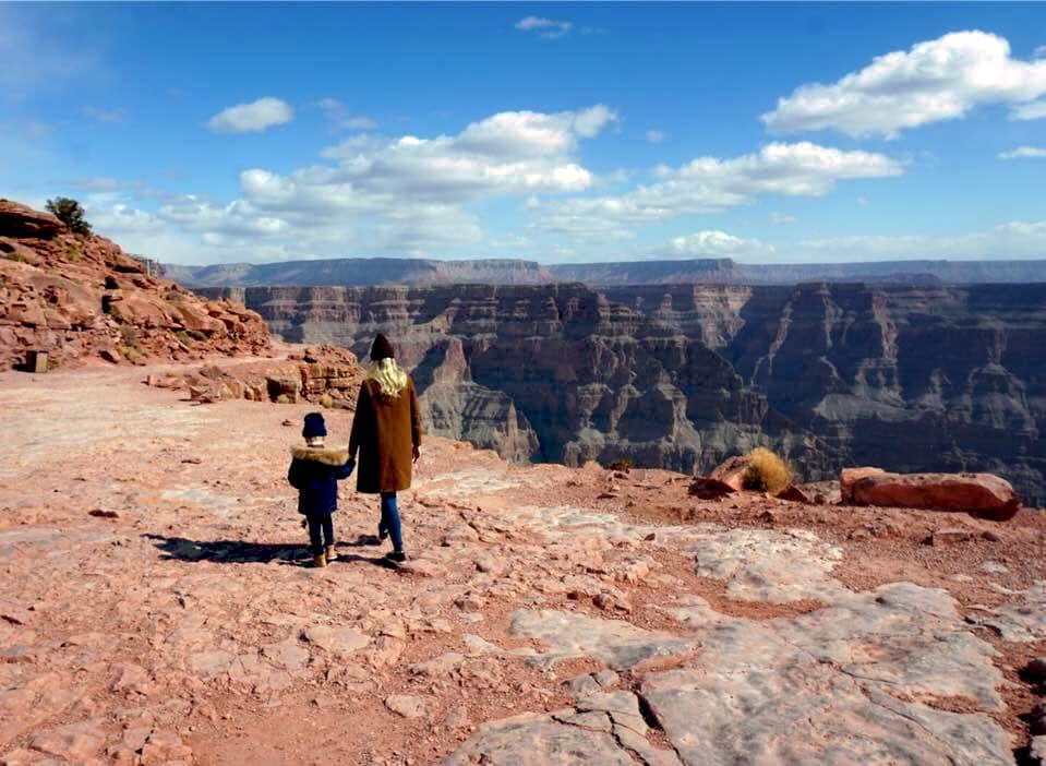 Mom and son walking in Grand Canyon, one of the best national parks for families.