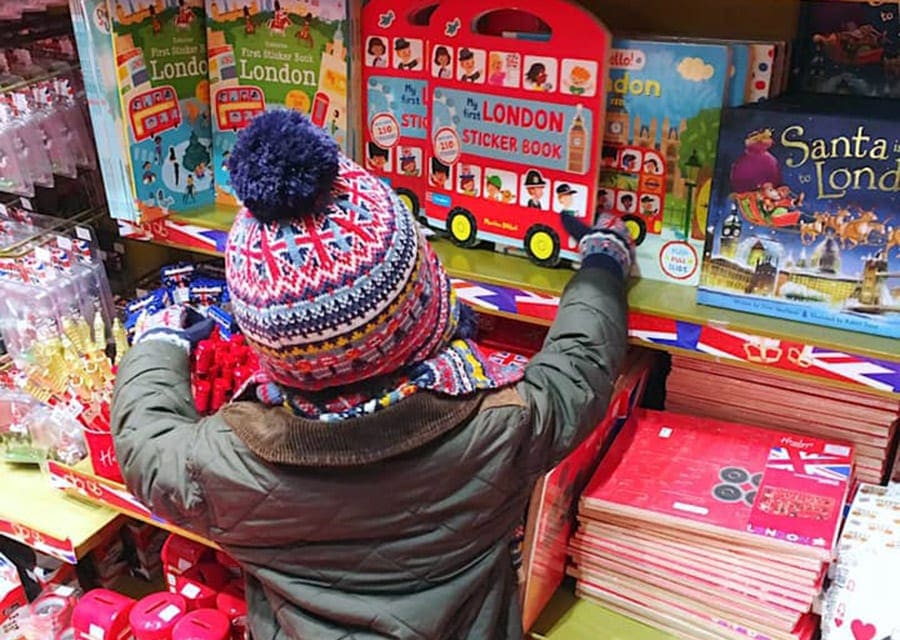 A young boy reaches out to well-stocked shelves of toys at Hamley's Toy Store in London.