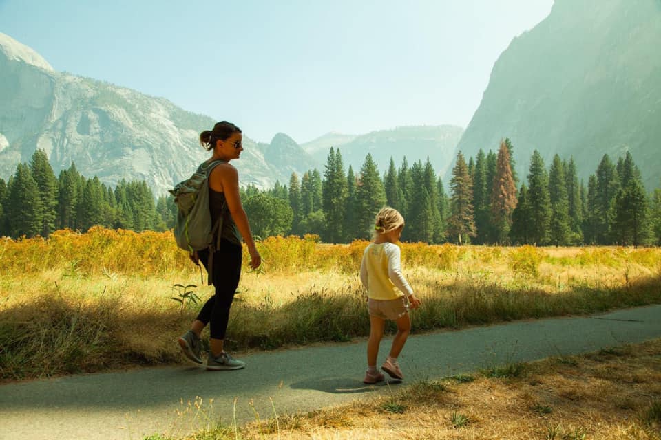 Women and girl on a walk at Yosemite National Park, one of the best national parks for families.