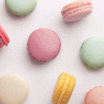 Several colorful macrons decorate a white background.