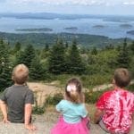 Three children on a hike enjoying the view at Acadia National Park