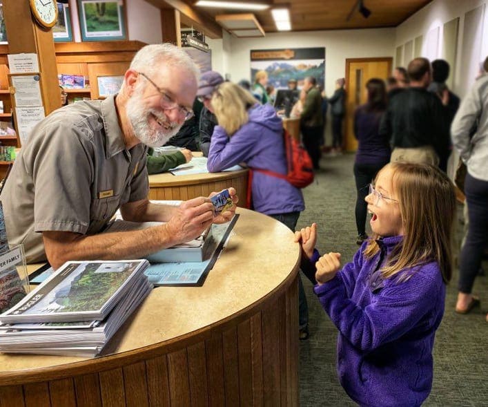 Girl getting exciting while receiving Free National Park Pass for 4th Graders