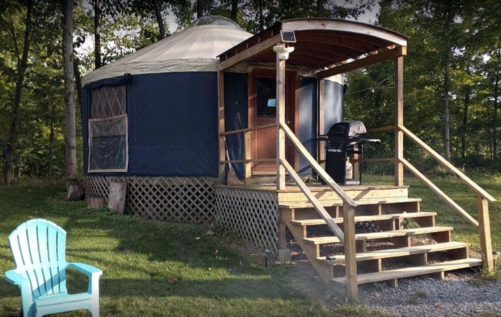 Blue yurt ar Log Village and Grist Mill Campground, Your Guide To Family Glamping in Style