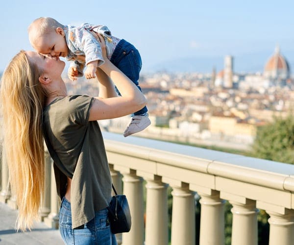 Mom holding a baby with Dromo (Florence) in the background