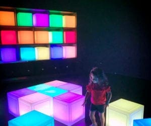 Young girl in front of colorful cubes in Singapore