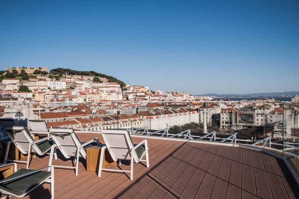 Several chairs overlooking a city view on the rooftop of Altis Prime Hotel, one of the best Lisbon hotels for families.