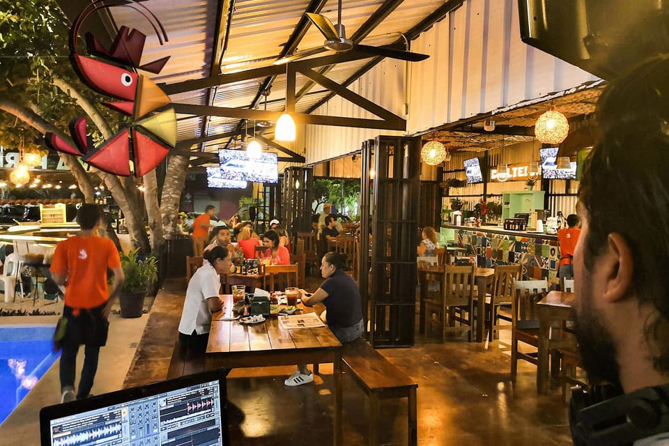 Inside Chiltepin Marisquillos, featuring a vibrant dining area with a number of patrons, colors, and activity.
