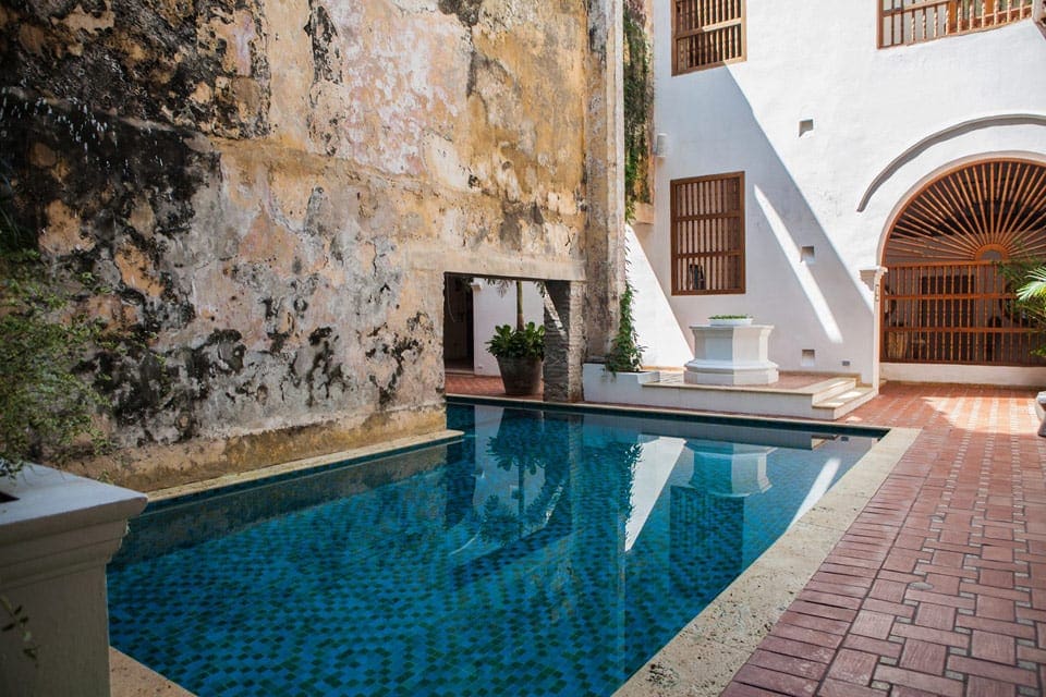 The charming pool at the Hotel Casa San Agustín, within a stone courtyard area.