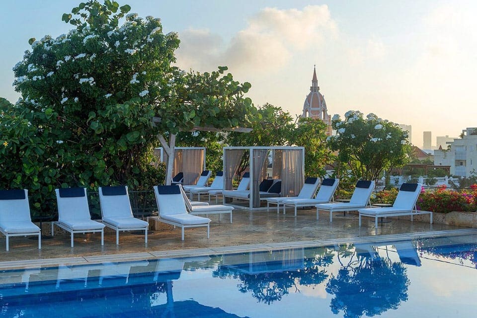 A view of the pool and poolside loungers at the Hotel Charleston Santa Teresa.