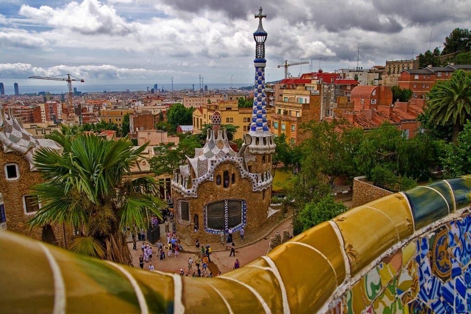 An arial view of the Parc Guell, behind its iconic mosaic tile wall.