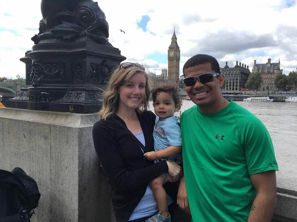 Family of three stands in front of Big Ben, one of the stops on our virtual travel from home to London.