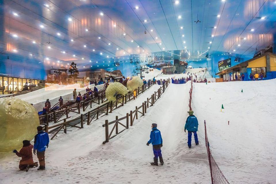 Several kids enjoy indoor snow while on skis at Ski Dubai.