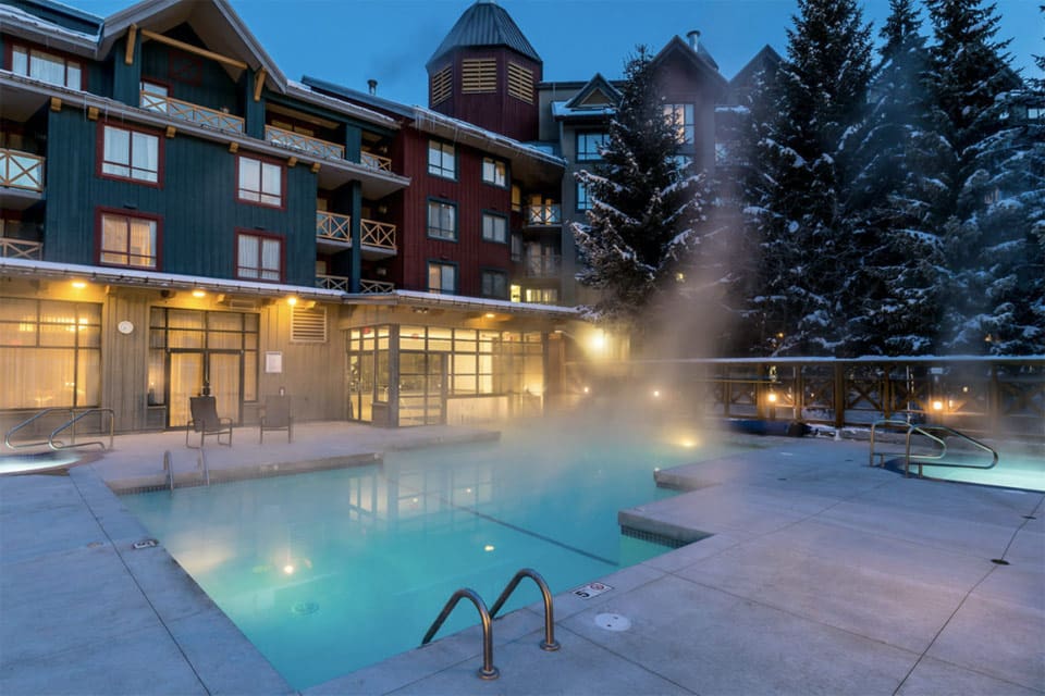 The outdoor pool at Delta Hotels by Marriott, one of the best family hotels in Whistler, featuring a steaming outdoor pool.