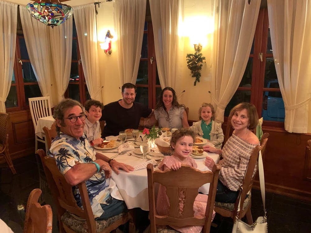 A family out to dinner at one of the best restaurants in Aruba for kids, Chalet Suisse.