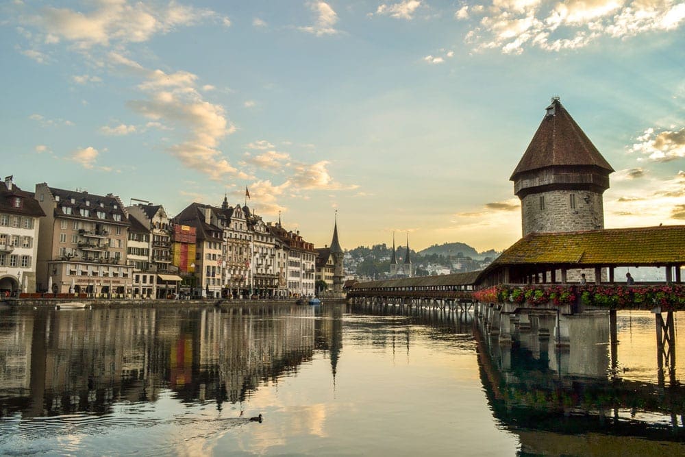 Landscape of Lucerne, with the river in the foreground and cityscape in the background.
