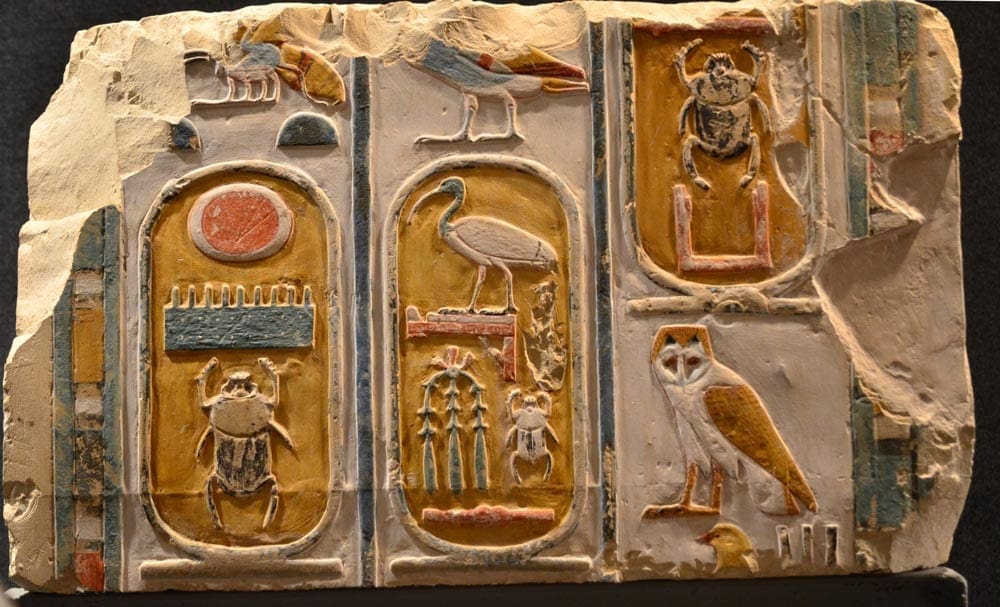 An Egyptian cartouche highlights several hieroglyphics.