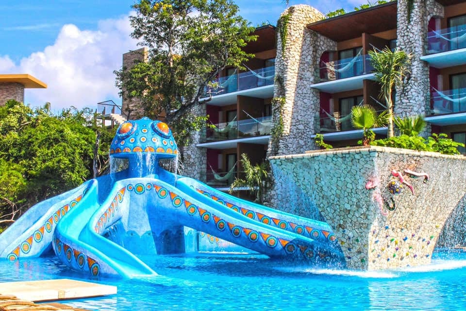 The water slide at one of the outdoor swimming pools at Hotel Xcaret, one of the best all-inclusive resorts Playa del Carmen for families.