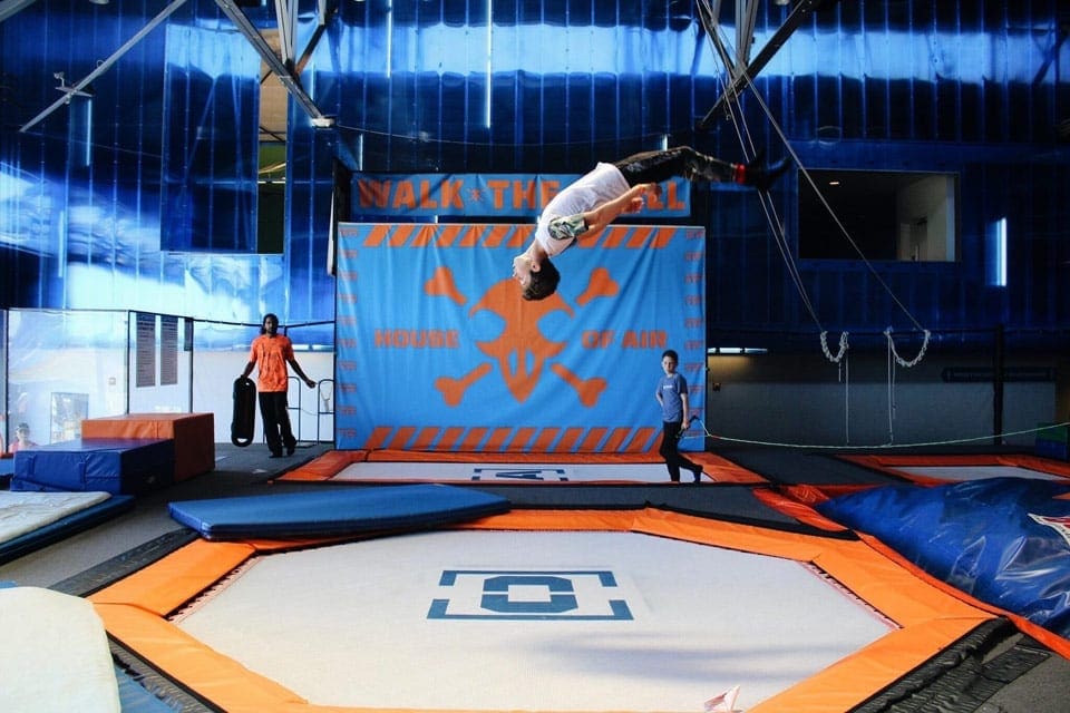 A teenager jumps on a trampoline at House of Air Trampoline Park, one of the best things to do in San Francisco with kids.