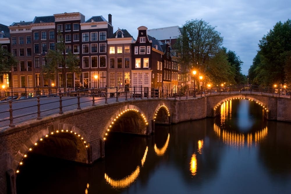 A view of the canal and a bridge within Amsterdam.