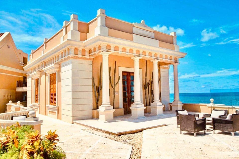 One of the resort buildings at the Sofitel Legend Santa Clara Cartagena, featuring large columns and brickwork. 