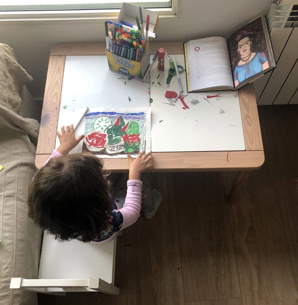 Little girl doing an Mexican-inspirted art project at a desk. Getting creative is a fun and exciting way to enjoy a virtual vacation to Mexico.