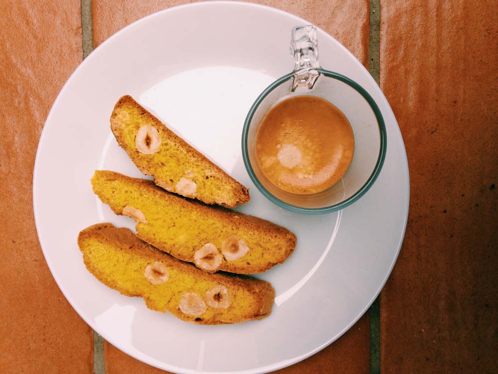 Espressoo with several macadamia nut biscotti, one of the best treats when visiting Rome with kids.