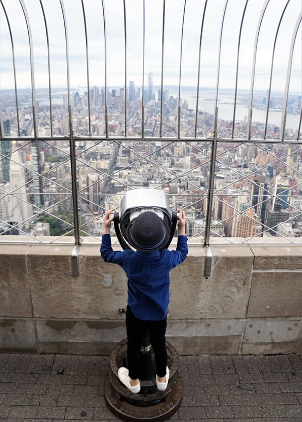 Little boys looking at the NYC skyline from the Empire State Building Telescope.