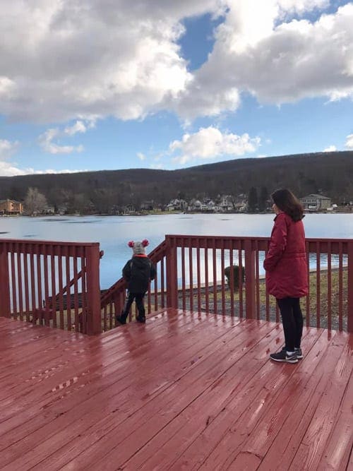 Mother and child playing on deck overlooking Greenwood Lake in New York.