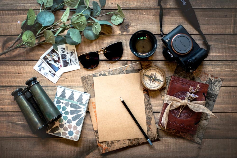 Glasses, binoculars, compass, writing pad, camera, and other travel gift suggestions for dad.