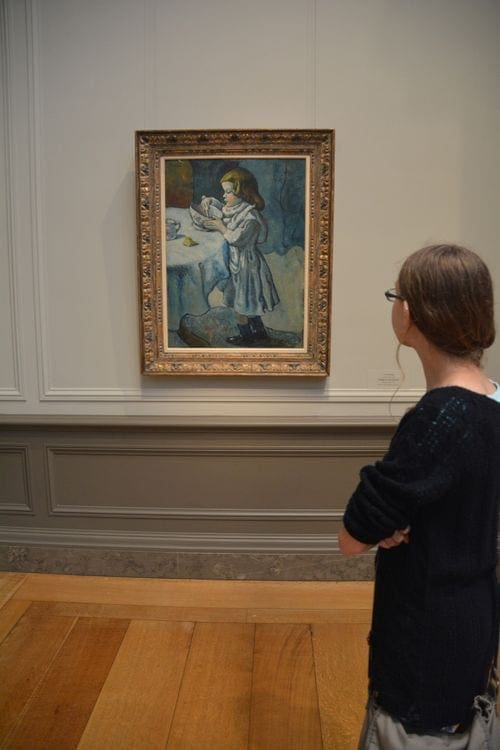 A young girl views a painting at the National Gallery.