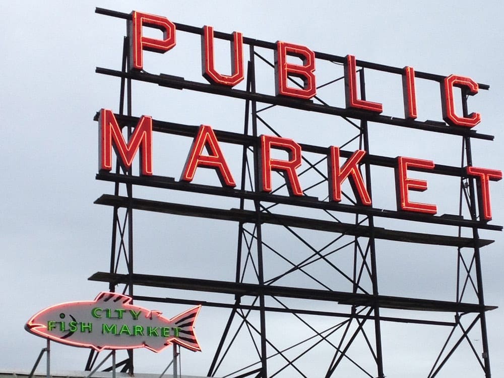 A view of the main sign at Pike Place Market, reading "Public Market". Pike Place is one of the best things to do in Seattle for families.