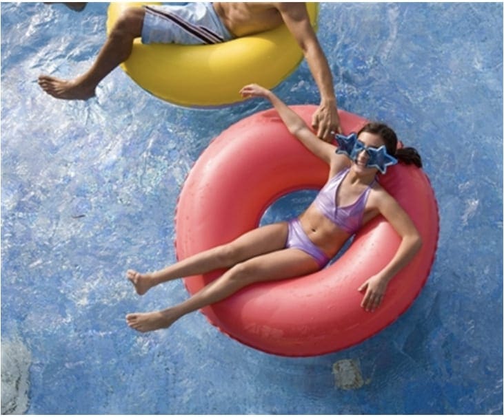 kids enjoying themselves at inflated tube in the pool