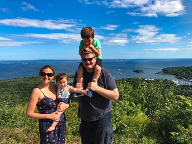 A family of four stands on a cliff over looking the Atlantic Ocean while hiking on the grounds of the Samoset Resort.