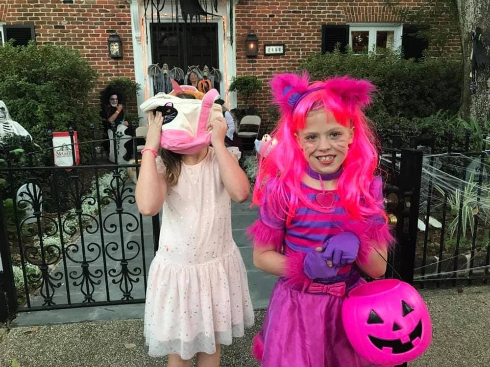 Two kids in costume go trick-or-treating in New Orleans, one of the best places to go for Halloween.
