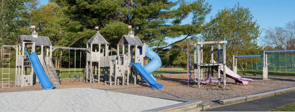 An extensive playground set at the Samoset Resort, one of the best Maine hotels for families, incluidng slides, swings, and more!