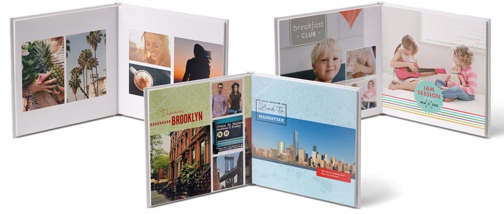 Three open family photo books featuring styles by Snapfish.