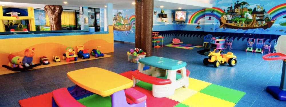 Inside the brightly colored baby club at Crown Paradise Club, featuring many toys.