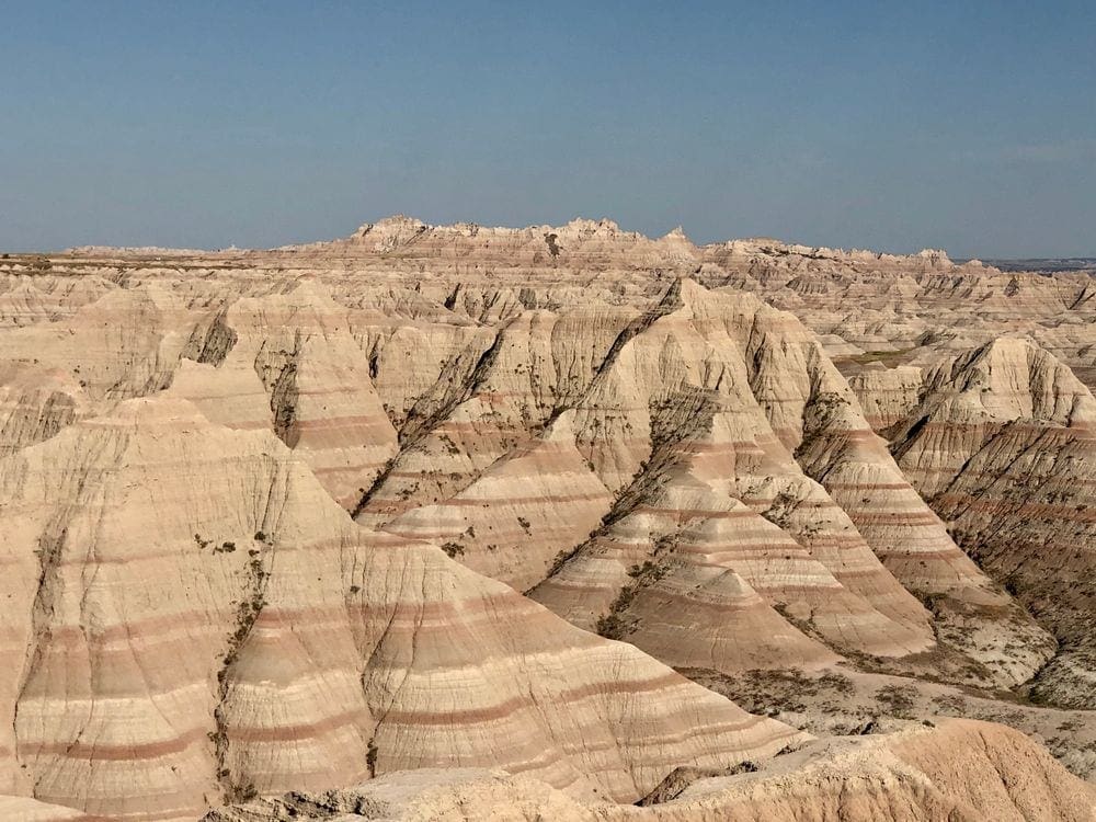A stunning view of the Badlands, one of the stops on this national park itinerary for families.