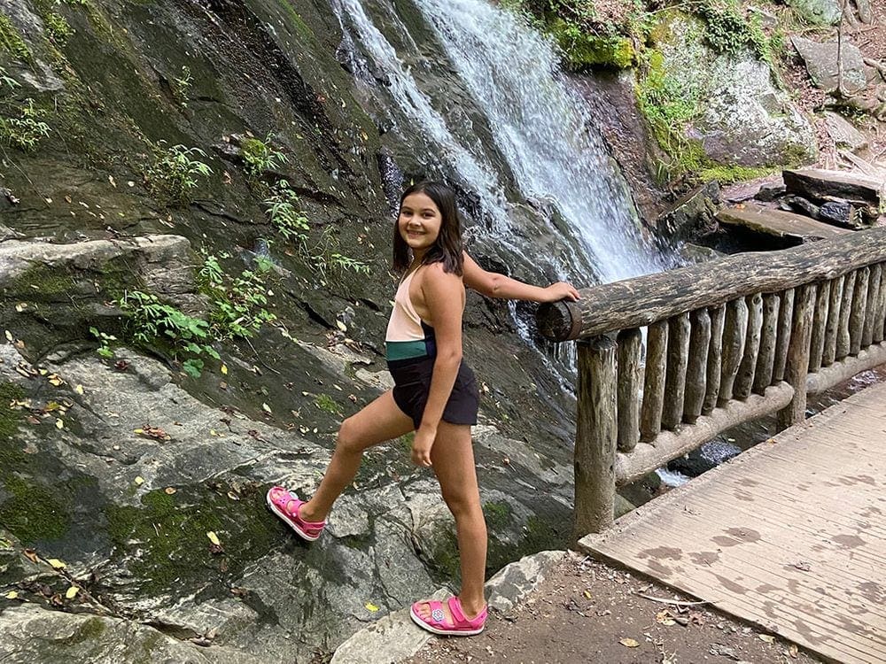 A young girl hikes at Juney Whank Falls.
