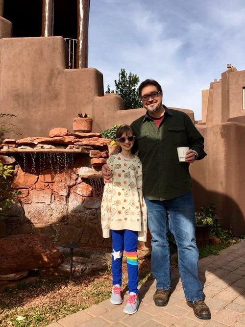 Dad and daughter stand outside of the Adobe Grand Villas Hotel in Sedona