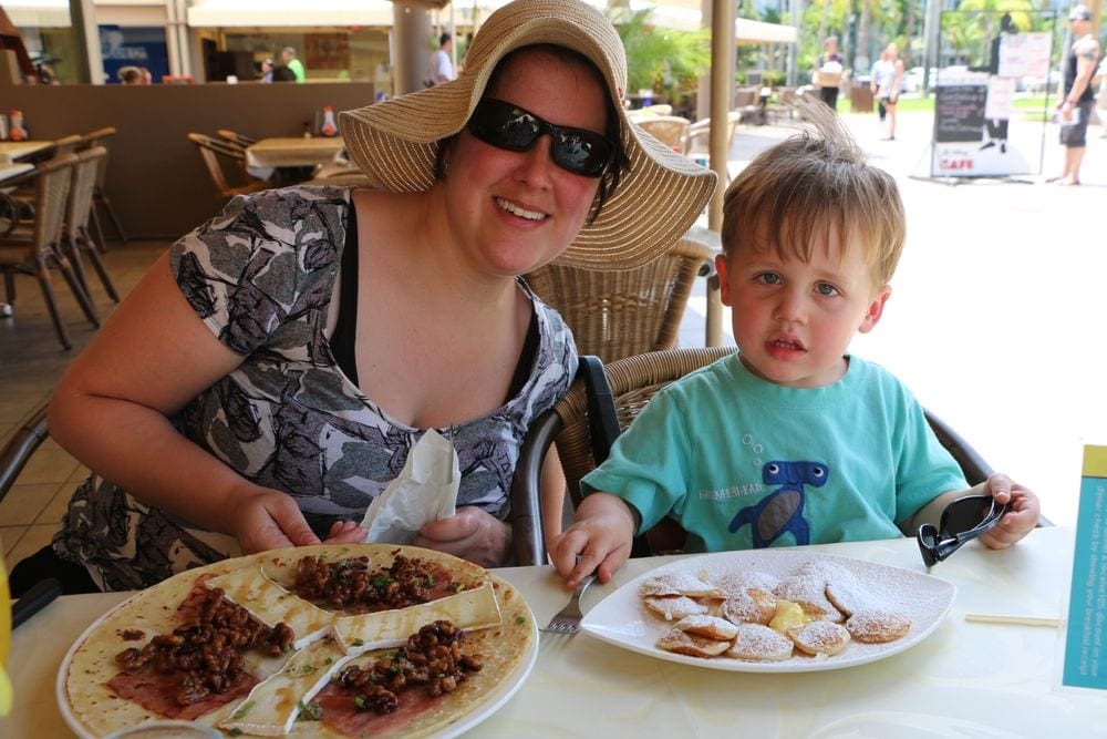 A mother and her young son enjoy pancakes at the Dutch Pancake House, one of the best restaurants In Aruba for families.