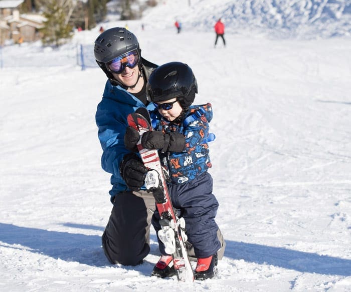 Dan with the toddler, teaching him to ski