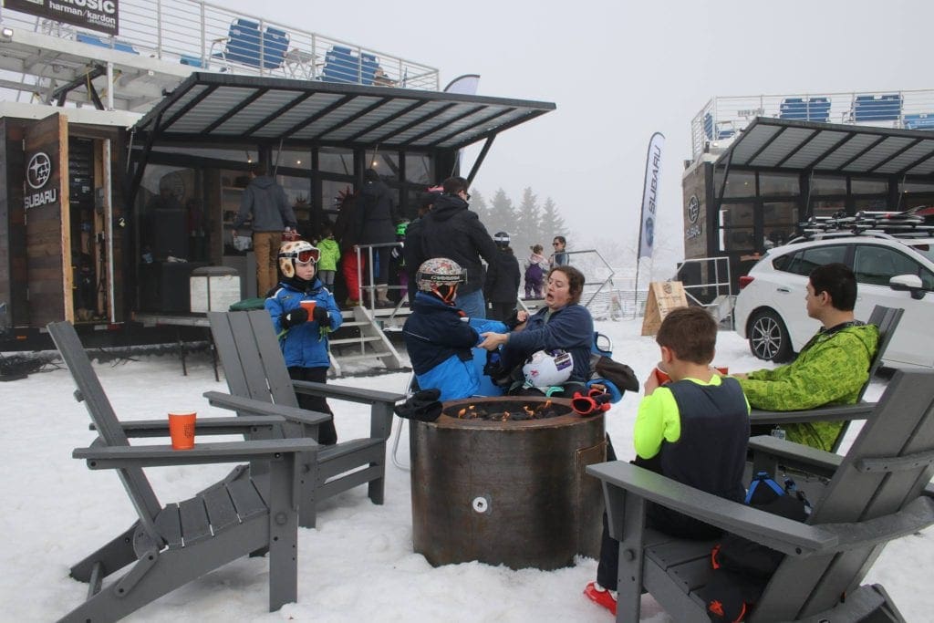 A family sits around a fire bin at Jack Frost Ski Resort.