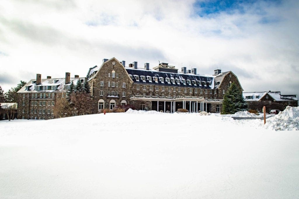 The exterior of the Skytop Lodge on a snowy, winter day.