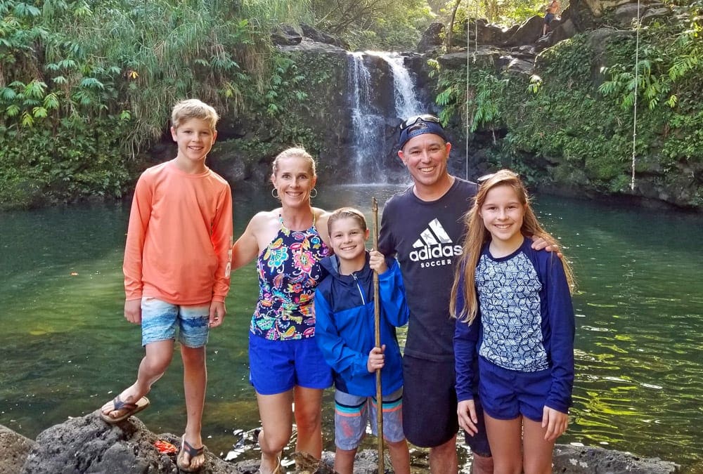 A family of five stands on the Road to Hana in Maui.